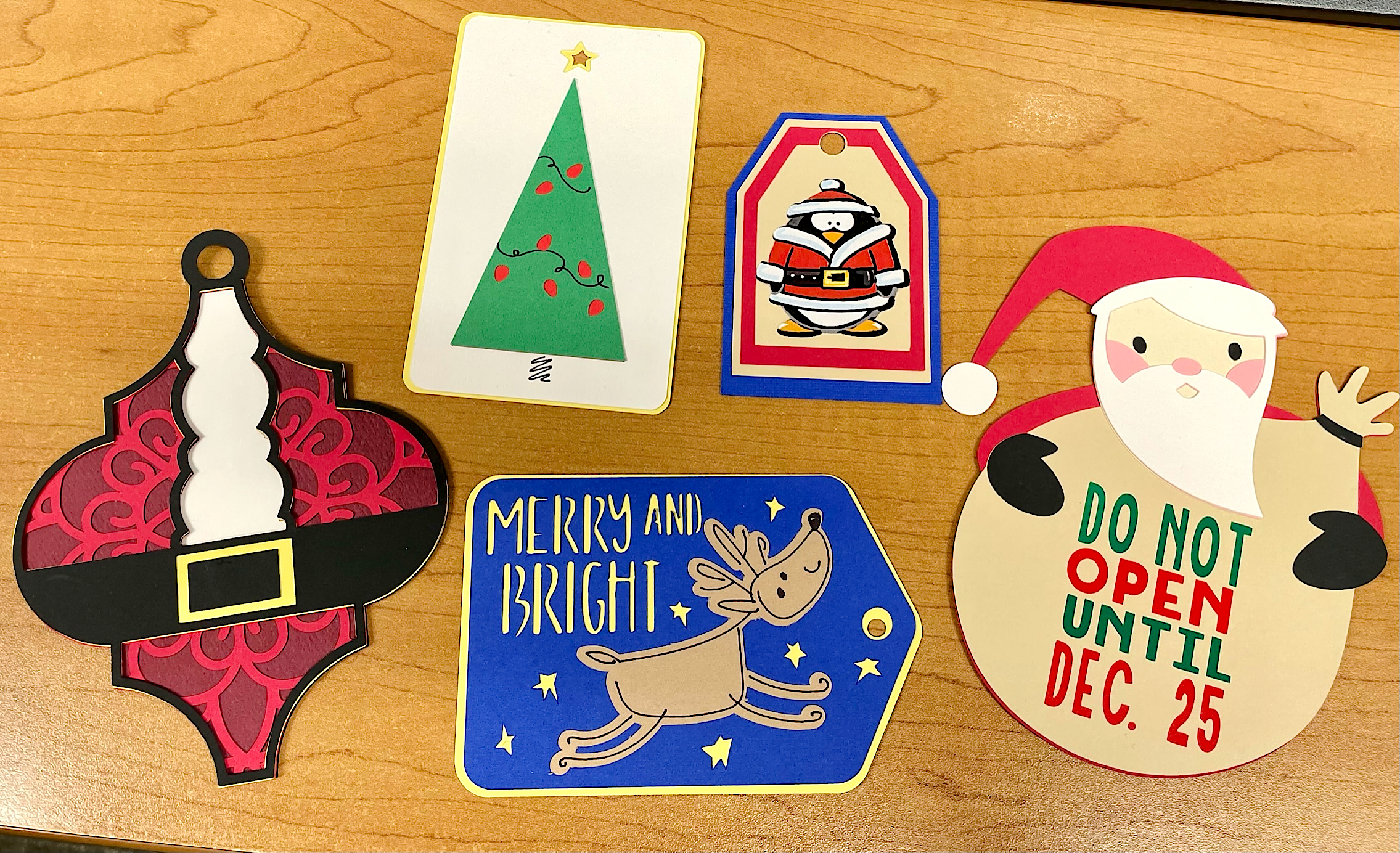 An assortment of handcrafted card stock Christmas gift tags.