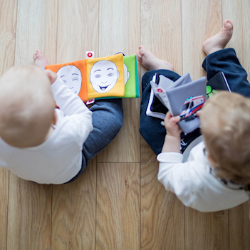 two babies looking at picture books