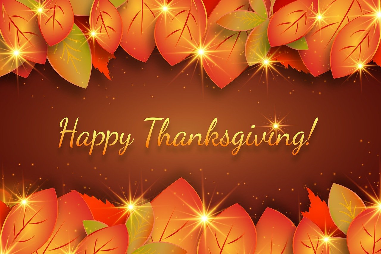 Autumn leaves border with "Happy Thanksgiving!" text and glowing sparkles on a brown background.