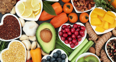 An assortment of heart-shaped dishes filled with plant-based food ingredients