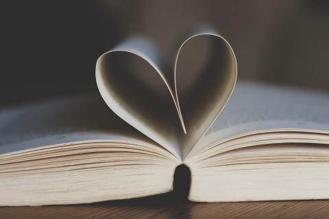 Open book with two pages folded into a heart.