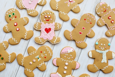 Multiple gingerbread people, each decorated in different ways.