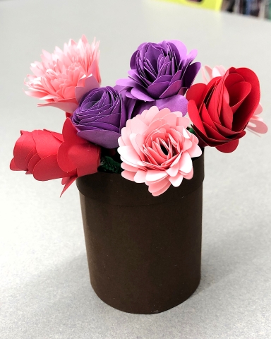 A paper planter with paper flowers.