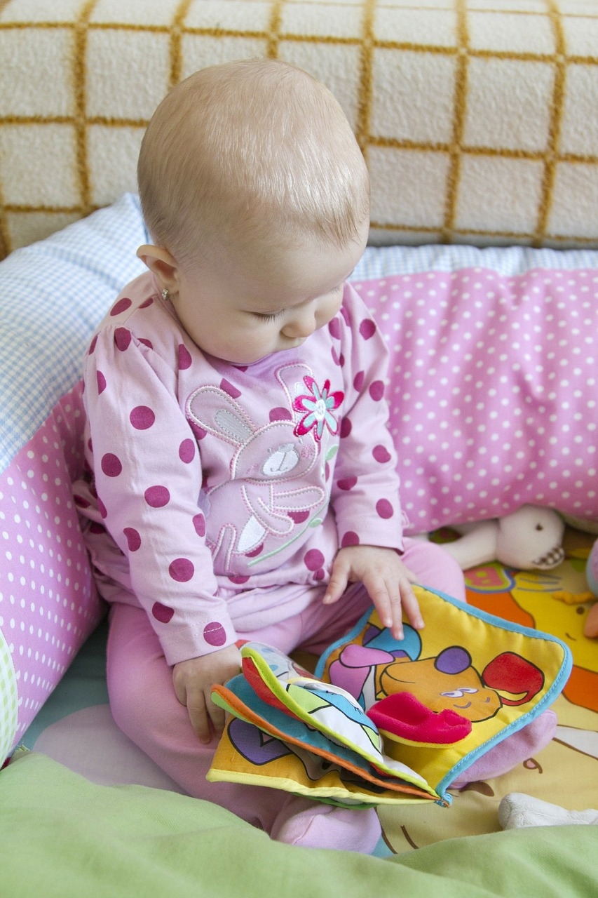 An infant with a cloth book