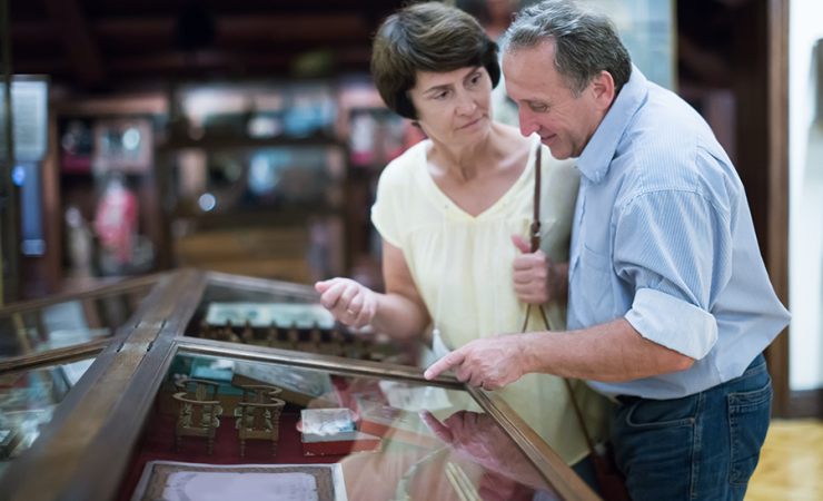 Man and woman looking into a glass case at a museum