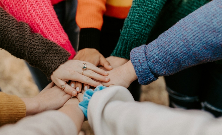 Group of people with hands coming together